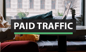 Paid Traffic with woman at computer background