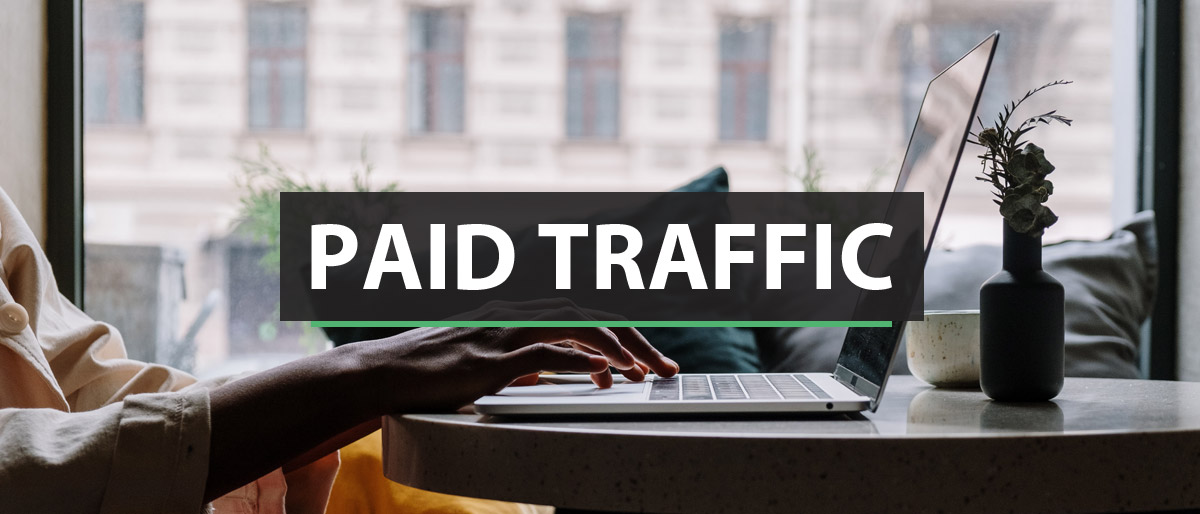 Paid Traffic with woman at computer background